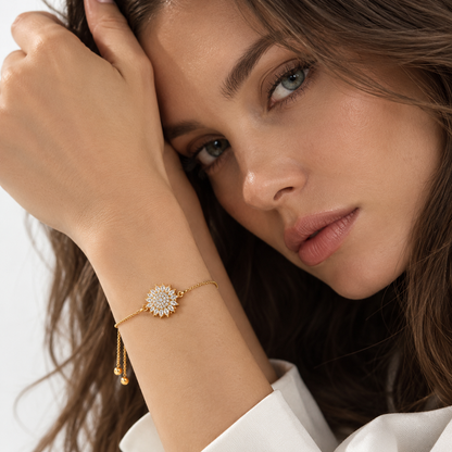 Gold sunflower bracelet worn on the wrist
