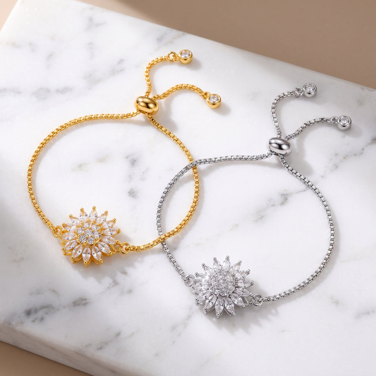 Gold and silver sunflower spinning bracelets on marble