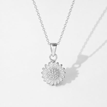 Silver sunflower spinning pendant on its chain