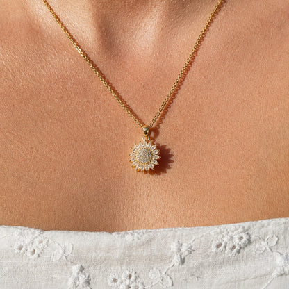 Gold sunflower pendant worn on the neckline