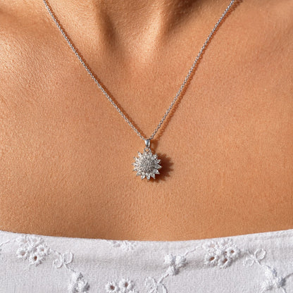 Silver sunflower pendant worn on the neckline