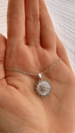 Sunflower pendant spinning in the palm of a hand
