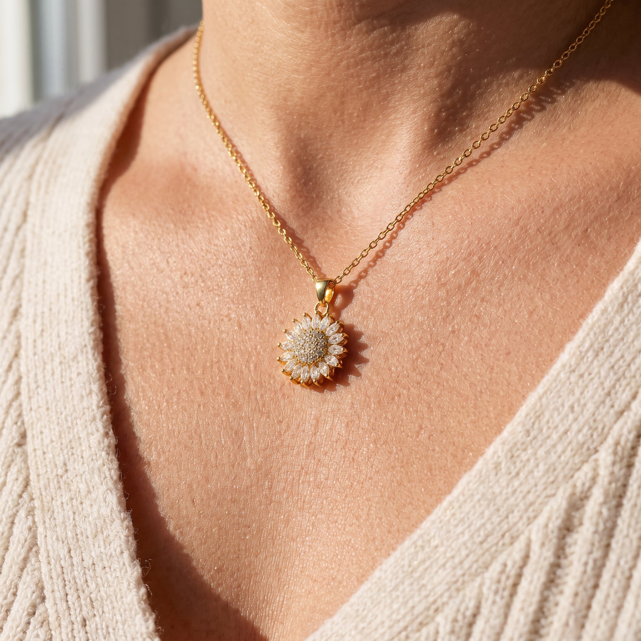 Gold sunflower spinning pendant worn on the neckline
