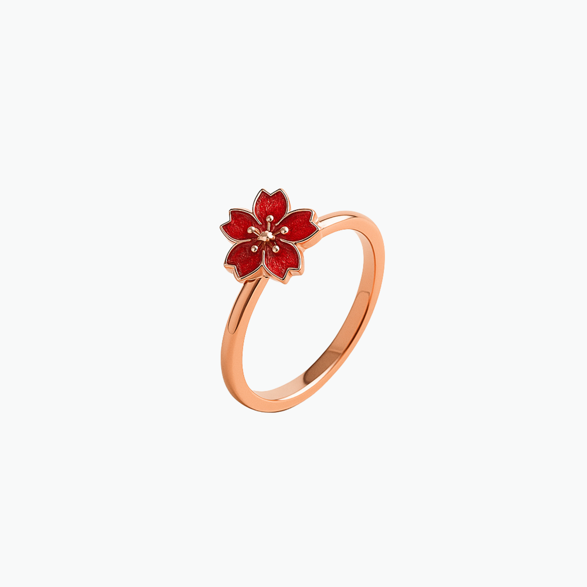 Rose gold ring with a spinning coral cherry blossom