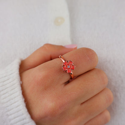 Rose gold blossom ring on a cream knit sleeve