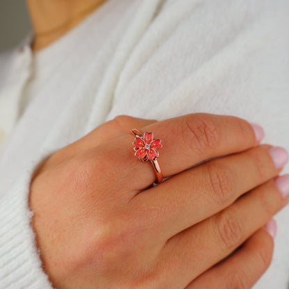 Hand resting on the chest wearing the blossom ring