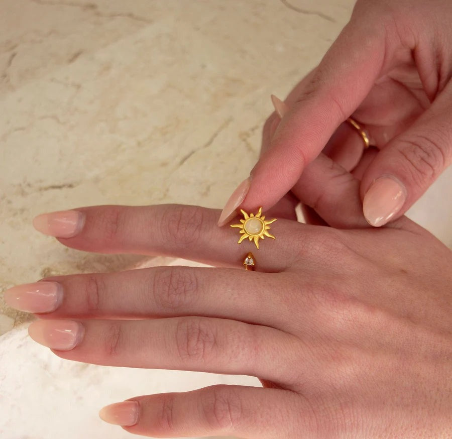Gold sun spinner ring worn on the hand