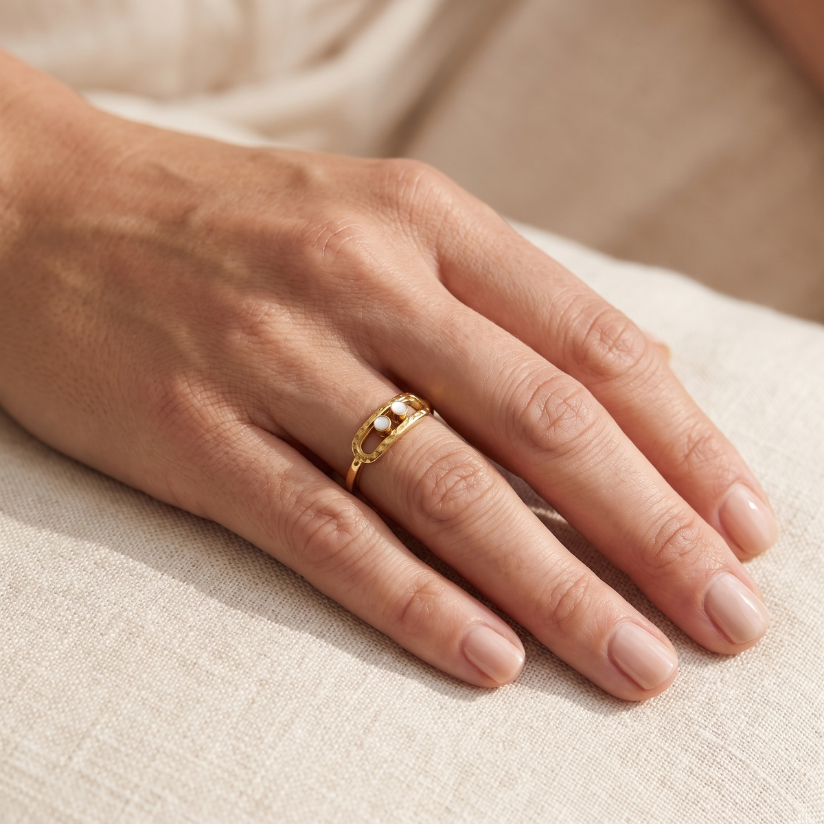 Gold 2-Bead Hammered Ring worn on the index finger