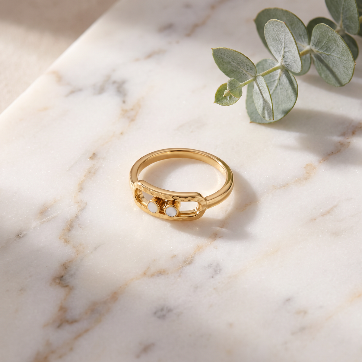 Gold 2-Bead Hammered Ring on white marble with eucalyptus