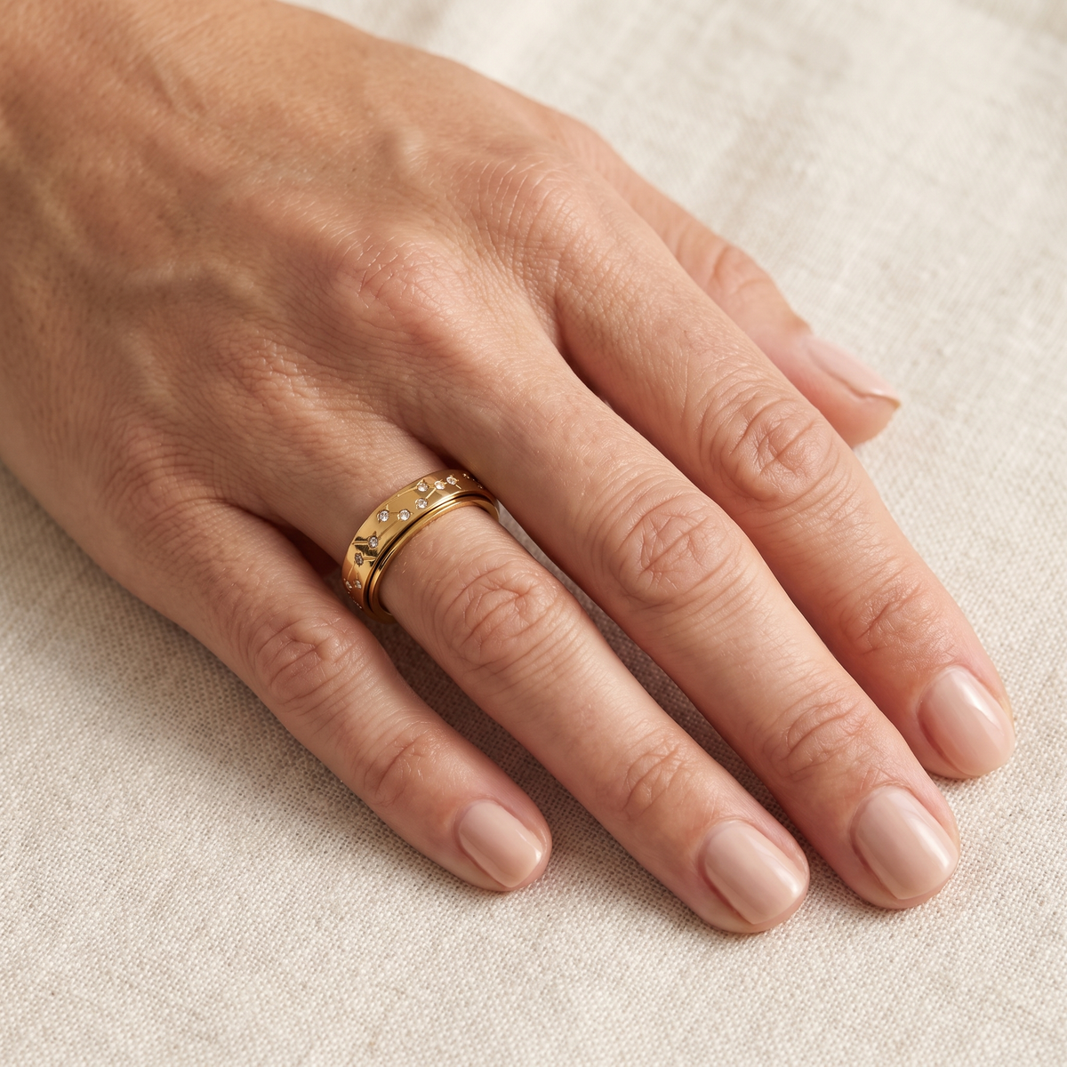 Gold Constellation Spinning Ring worn on the index finger