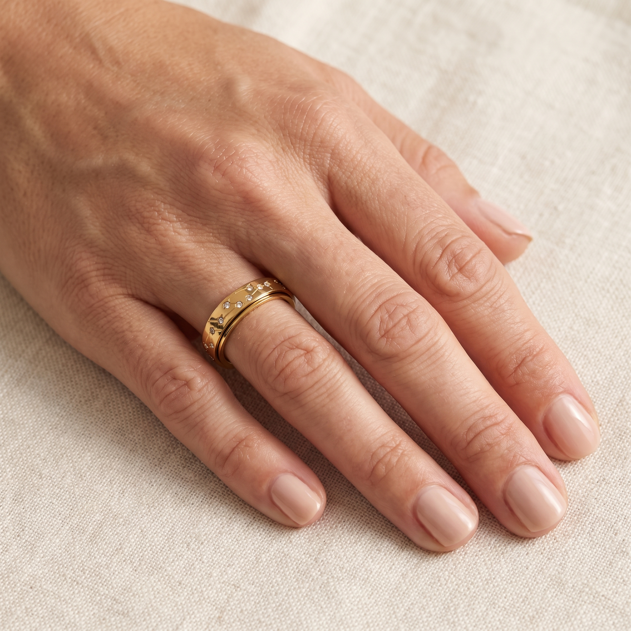 Gold Constellation Spinning Ring worn on the index finger