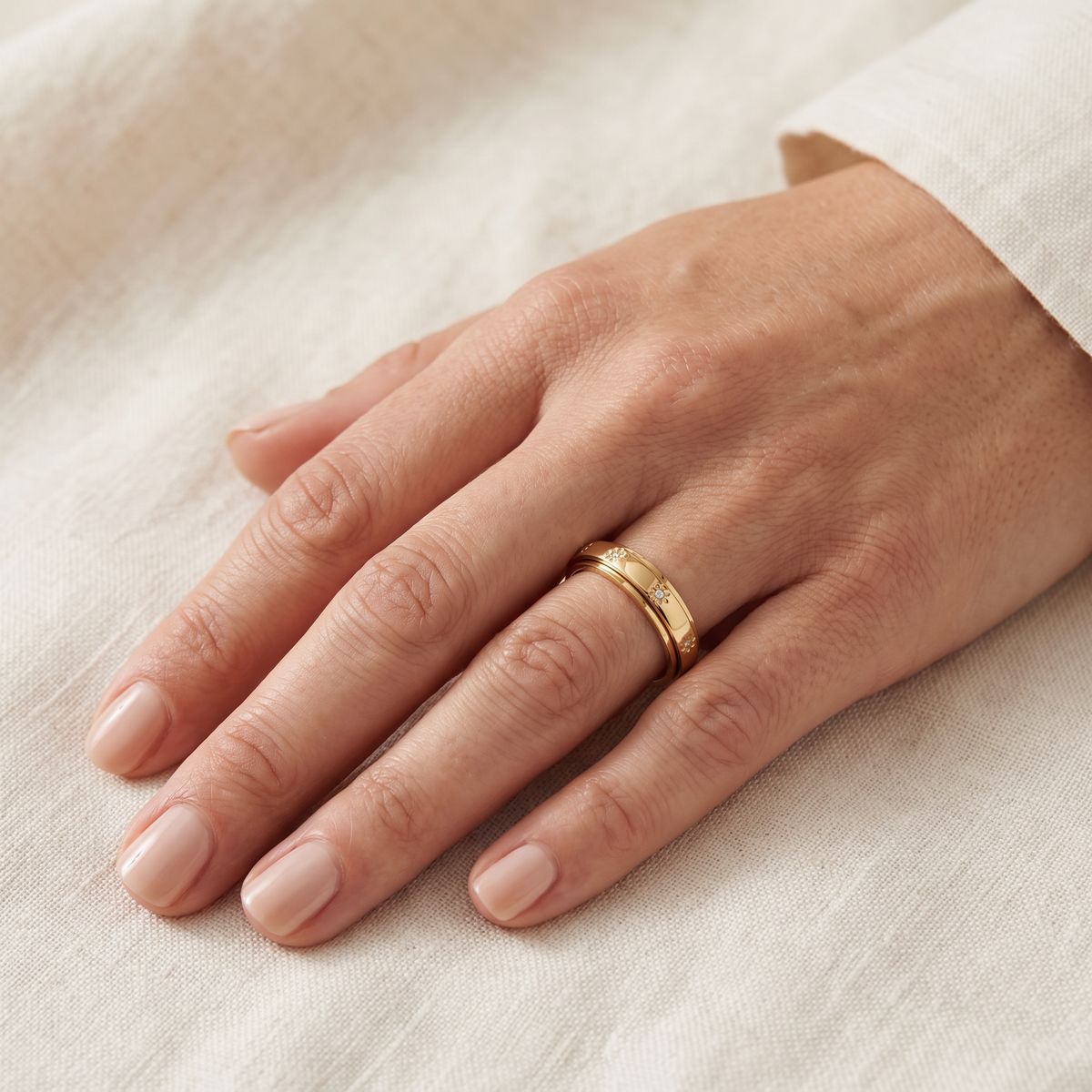 Gold Star Spinning Ring worn on the index finger