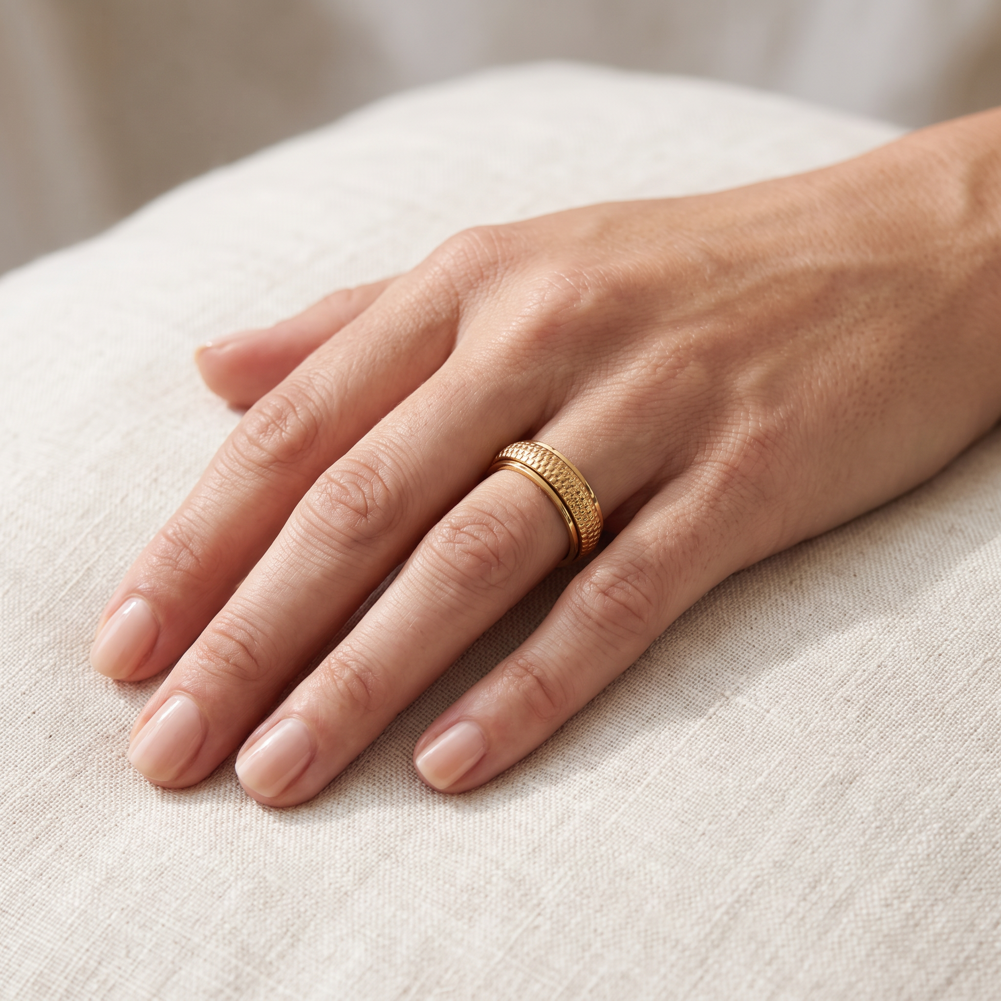 Gold Woven Spinning Ring worn on the index finger