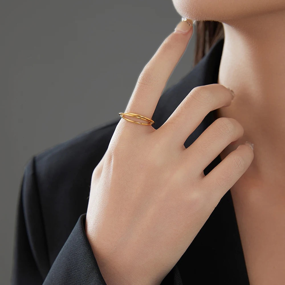 Hand near the chin wearing the gold braided ring