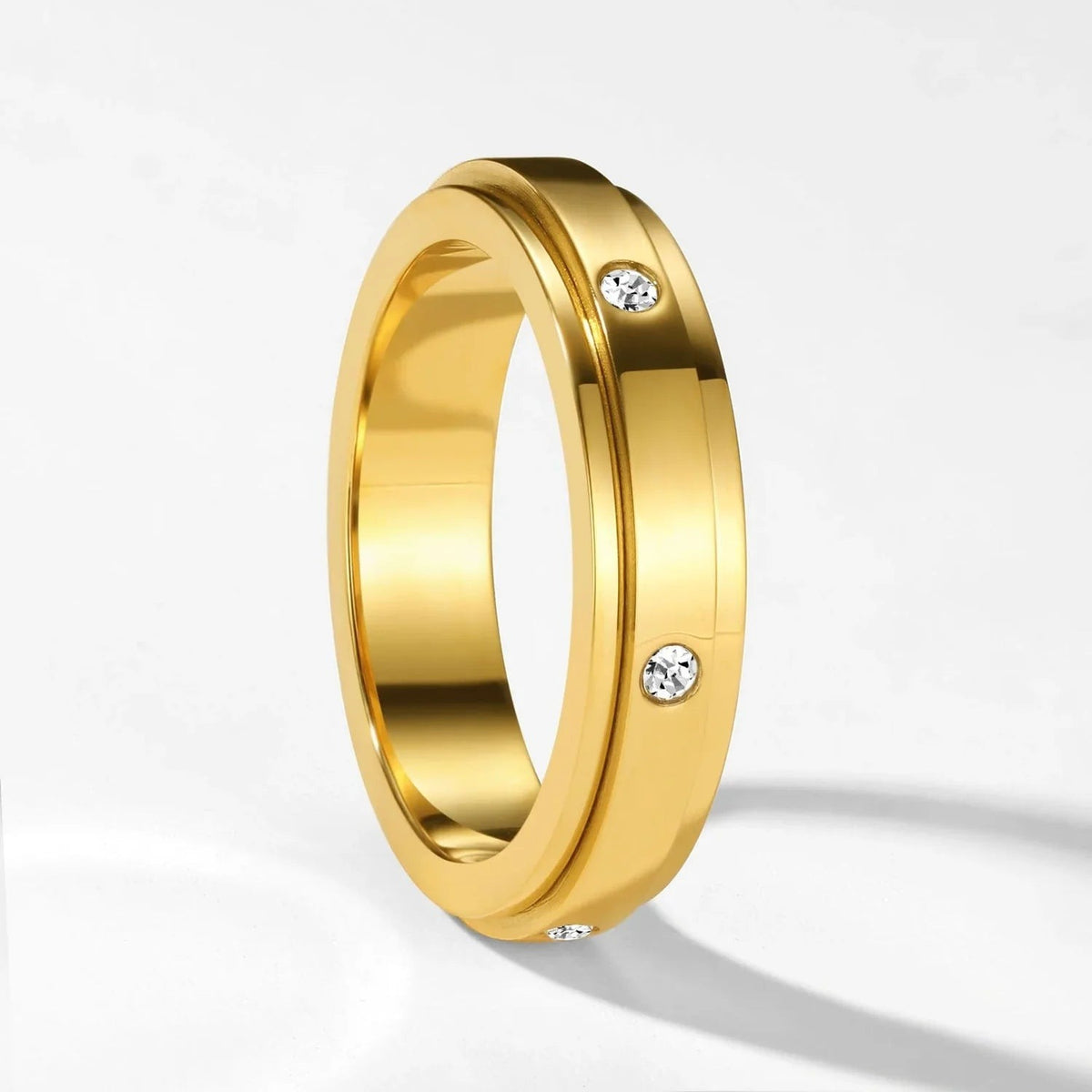 Gold spinner ring with three sparkling stones