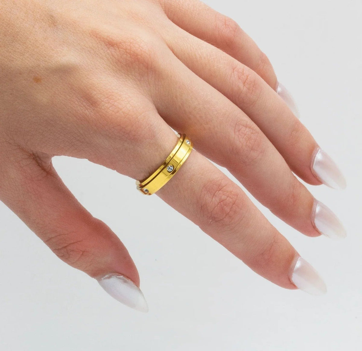 Gold spinner ring worn on the hand