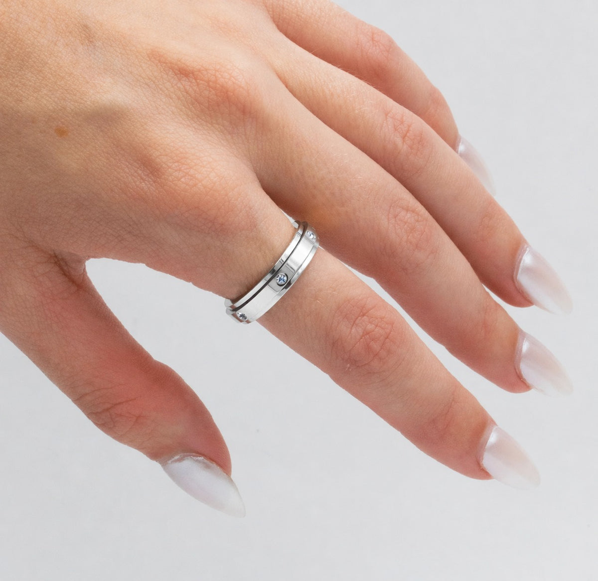 Silver spinner ring worn on the hand