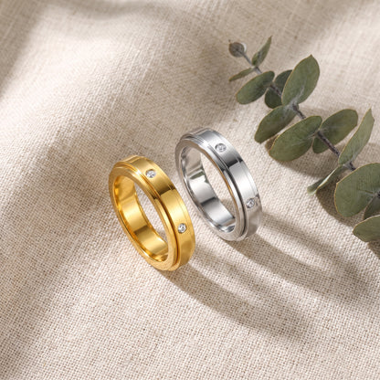 Gold and silver spinner rings on linen with eucalyptus