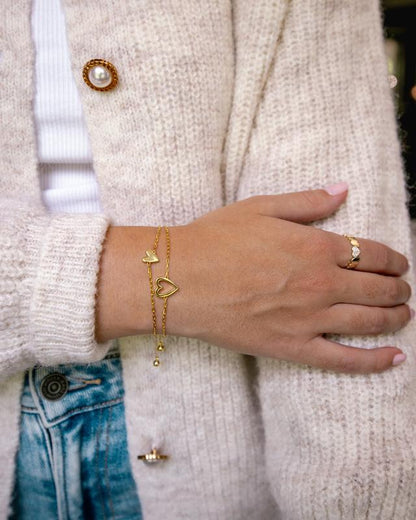 Heart bracelet worn with a cozy cardigan