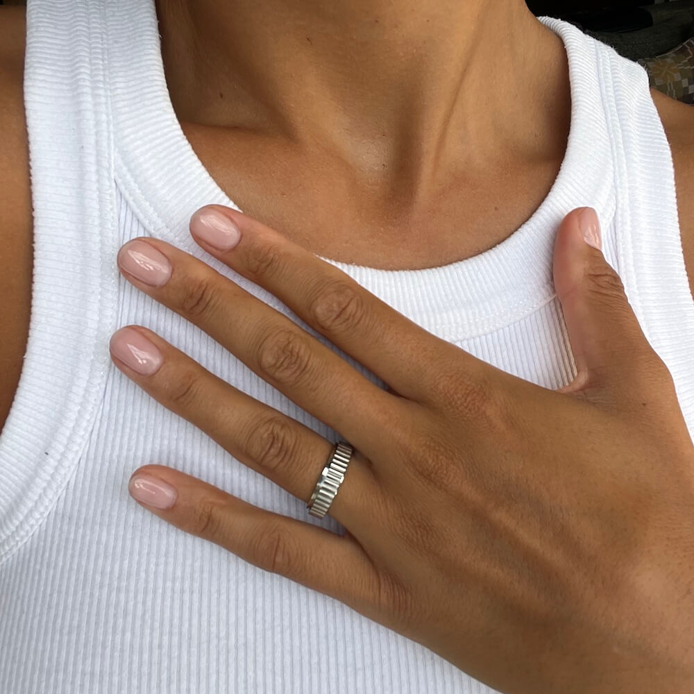 Silver grooved spinning ring worn on the hand