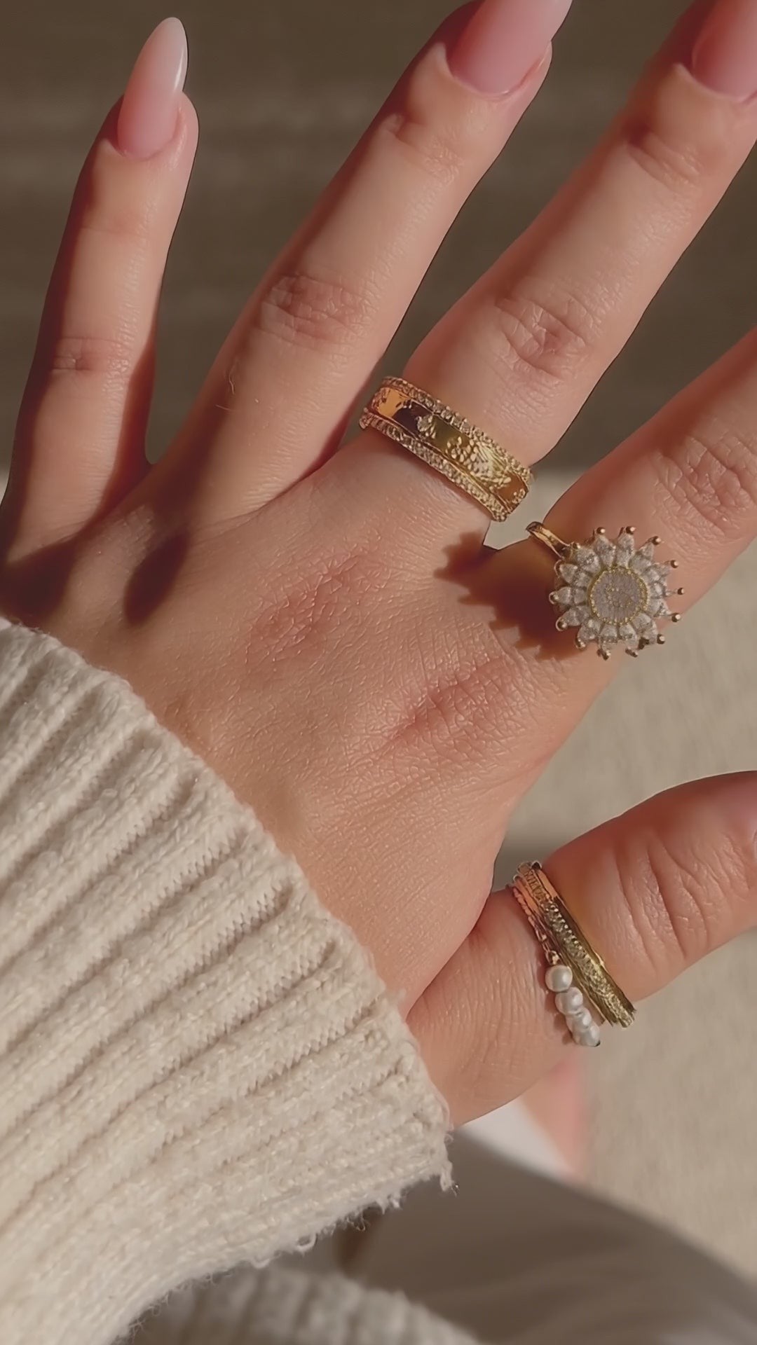 Gold crystal sunflower ring stacked with other rings